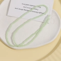 Macro detail of 5x3mm light green cylindrical beads on a white tray for DIY jewelry - Light Green