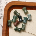 Macro shot of spool-shaped red agate and jade beads for DIY jewelry making - Green Flower Stone