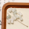 Macro detail of white and pale green dumbbell-shaped stone beads for DIY jewelry making - Light Green White Stone