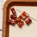 Macro shot of polished red agate hourglass-shaped loose beads for DIY jewelry making - Red Agate