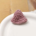 Detailed macro view of a handmade pink crochet mini hat for DIY jewelry and doll crafts - Pink