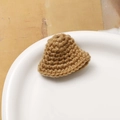 Close-up of handmade crochet mini bucket hat with spiral texture for DIY accessories - Yellow