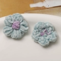 Detail showing the plush texture and structure of blue and purple hand-knitted flower petals - Lake Green Purple Core