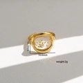 Detailopname van de handgemaakte roestvrijstalen ring met witte droogbloemen in gouden rand - Stijl 213