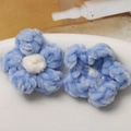 Close-up of handmade crochet puff flowers in soft blue and white chenille yarn - Blue White Heart