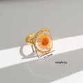 Detailed view of handmade dried orange flower embedded in clear resin ring with dimensions - Style 358