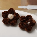 Macro detail of handmade brown and white fuzzy puff flowers for DIY craft accessories - Brown Petal Coffee Core