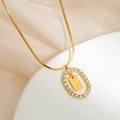 Elegant 18K gold snake chain necklace featuring a sparkling crystal pendant with letter K - Letter K