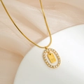 Golden stainless steel snake chain necklace with rhinestone oval pendant and letter N - Letter N