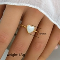 Twisted gold ring with a white enamel heart charm and refined rope texture band - Twisted Shell Heart Ring (243) / 8.4mm