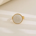 Macro detail of a gold-plated ring with a white spiral enamel inlay and fine double-band structure - Round Swirl Texture Design / Gold