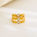 Macro detail of gold-plated stainless steel open ring with white enamel dots - Triple Row Dot Design / Gold