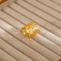 Detailed macro view of vintage baroque gold hollow-out carved ring on linen texture - Gold Hollow Carved Vintage Style (81)