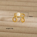 Detail view of gold stainless steel ring with white cat eye stone and cross curve design - Oval White Cat Eye Stone Look Style (119)