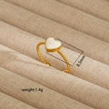 Detail view of gold twisted ring featuring an 8.5mm white heart inlay on jewelry box - Twisted Rope Heart Style (243) / Gold