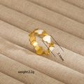 Detailed view of 7.1mm irregular gold-plated heart ring with white enamel accents - Surrounding Heart Style (244) / Gold