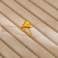 Close-up of golden heart ring with detailed rope texture band on beige fabric - Gold Twisted Rope Polished Heart Style (142)