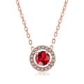 Detail of round red zircon pendant with halo diamonds on gold chain with reflection - Rose Gold Red Stone