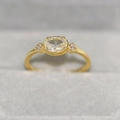 Polished 14k gold plated ring featuring an oval zircon center stone in a four-prong setting - US 5 / 14K Light Gold White Stone
