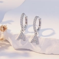 Silver letter A hoop earrings with cubic zirconia on a white stone background - Silver A