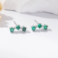 Close-up of triple green zircon studs in 925 silver setting with a minimalist style - Silver Green Zirconia