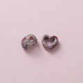 Macro detail of camouflage ceramic heart beads with holes for DIY jewelry making - Red Blue Gray Brown Kiln Glaze (7#)
