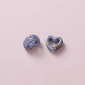 Macro detail of camouflage ceramic heart beads with glazed texture for DIY jewelry making - Blue Green Brown Marble (1#)