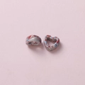 Macro detail of camouflage heart ceramic beads with red blue ink splash and side hole - Light Gray Red Blue Ink Wash (13#)