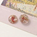 Macro shot of resin jewelry parts with dried flowers and gold foil on artistic cards - No.4 Red Dried Flower
