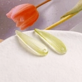 Detailed view of light green leaf-shaped glass charms with vertical stripes for DIY jewelry - 121# Light Yellow