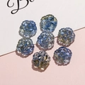 Macro shot of 7 blue and white gradient flower beads for DIY jewelry making - Blue-Yellow