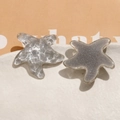 Macro detail of starfish resin charms in transparent ripple and silver glitter styles - Gray One (B53-4-14-19)