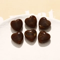 Detailed view of 6 heart-shaped acrylic beads with brown marble texture in a white tray - 1 Piece / Coffee