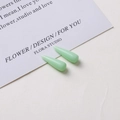 Close-up of small mint green teardrop resin charms for DIY earring and jewelry making - 9# Light Green