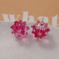 Two pink matte acrylic sea urchin beads for DIY jewelry making on a white tray - Ice Translucent Rose Red