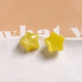 Detailed view of yellow glitter star resin charms for DIY jewelry and phone case decor - Yellow