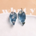 Detail of blue resin conch charm with white rhinestones and a golden metal ring - Blue