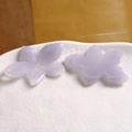 Macro detail of hand-carved purple resin flower charms showing front and back texture - Purple