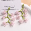 Detail of handmade lavender beaded flower tassels with frosted glass petals and green stems - Peach Pink