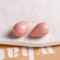 Macro detail of glossy light pink teardrop resin pendants for DIY jewelry making - Pink