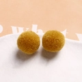 Macro detail of warm yellow 20mm plush pompoms for DIY jewelry and hair accessories - Yellow Coffee