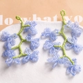 Handmade woven blue glass flower earrings with green stems in a white ceramic tray - Dark Blue