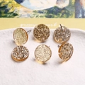 Détail macro de six boucles d'oreilles en résine avec paillettes dorées et argentées en bol - Particules Brillantes Jaune Clair