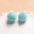 Close-up of light blue 20mm plush pom-poms for DIY jewelry and hair accessory crafts - Cyan