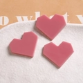 Three pink geometric acrylic heart charms for DIY jewelry on a white ceramic plate - Pink Heart Style
