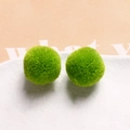Close-up of bright green 20mm plush spheres with soft fuzzy texture for DIY crafts - Fruit Green