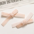 Close-up of a pair of light pink velvet bow hair clips with soft textured ribbon detail - Chrysanthemum Pink