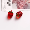 Macro shot of transparent red strawberry resin charms for DIY jewelry making - Red