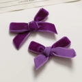 Close-up of deep purple velvet ribbon hair bows with soft texture and rich sheen - Purple