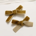 Close-up of mustard yellow velvet bow hair clips with ribbed ribbon backing and texture - Light Coffee